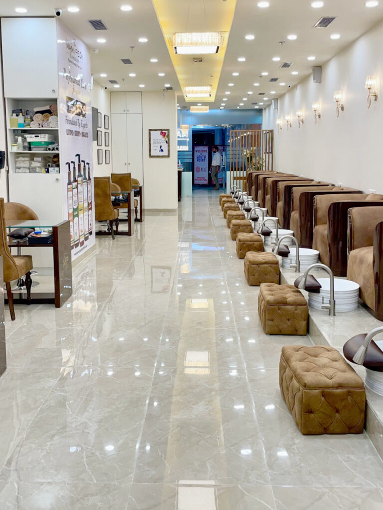 Modern and elegant interior of The Mani Pedi Spa franchise featuring plush pedicure stations